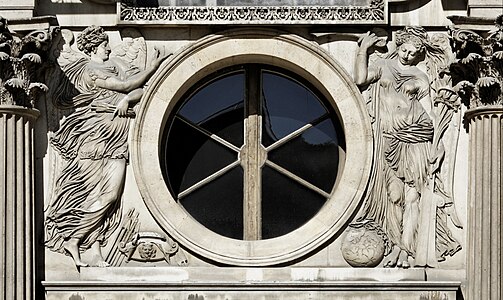 Renaissance medallion-like oculus on the west facade of the Cour Carrée of the Louvre Palace, with figures of war and peace, sculpted by Jean Goujon and designed by Pierre Lescot, 1548[10]