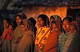 K6 Women waiting for something one chilly morning in Deogarh, Orissa.