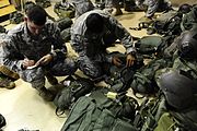 Two Rangers inspect their gear before the Ranger Rendezvous, a mass tactical jump conducted by elements from the entire Regiment, 3 August 2009