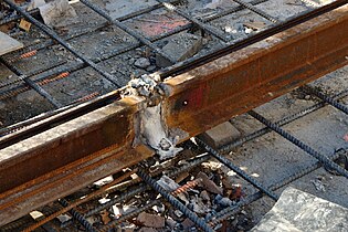 A rough exothermic weld after removal of the mould, before grinding to profile