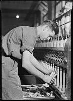 High Point, North Carolina. Pickett Yarn Mill. Doffer in action.