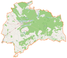 Mapa konturowa powiatu augustowskiego, po lewej nieco na dole znajduje się owalna plamka nieco zaostrzona i wystająca na lewo w swoim dolnym rogu z opisem „Kroszewo”