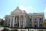 Type of site: City Hall. The Market Square was the centre around which the city of Kimberley grew. It was the scene of many important events in the history of this city, and of South Africa and Zimbabwe. The City Hall was designed by F C Rogers in the neo-classical style.