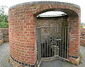 The chimney on top of the furnace. The new outer wall has a gap for viewing the original inner wall (badly damaged by overheating) and down into the furnace