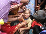 K30. A boy in Bihar receiving his first hair cut.