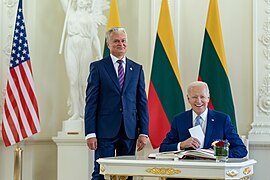 American President Joe Biden signing in a guests book in the White Hall nearby Lithuanian President Gitanas Nausėda