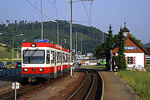 Red-and-white electric train outdoors