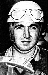 Black and white photograph of Alberto Ascari wearing racing uniforms and sitting in an open-wheel car