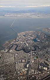 View directed east, showing US 101 interchange, serpentine Seal Slough, and the San Mateo Bridge