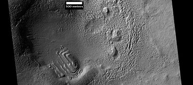 Layered structure in crater that is probably what is left of a layered unit that once covered a much larger area. Material for this unit fell from the sky as ice-coated dust. The picture was taken by HiRISE, under the HiWish program.