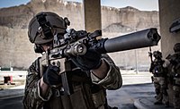 Belgian SFG soldier armed with the SCAR-L with a suppressor