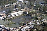 large areas of still water behind riverside buildings