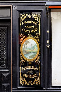 Neoclassical medallion on the facade of Le Moulin de la Vierge (Rue Saint-Dominique no. 64), Paris, by Benits et Fils, c.1900[14]