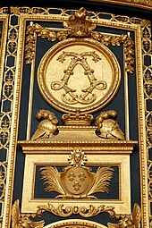 Baroque monogram of Louis XIV made of acanthuses, on the entrance door of the Dôme des Invalides, Paris, designed by Jules Hardouin-Mansart, 1677–1706[10]