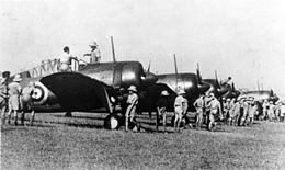 Row of single-engined military monoplanes parked on an airfield