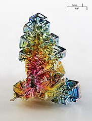 Synthetic bismuth crystal. Photo by Alchemist-hp (www.pse-mendelejew.de) + Richard Bartz