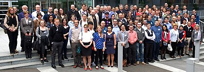 A group of scientists at a meeting posing outdoors