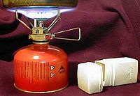 A small portable stove running on MSR gas and the stove's carrying case