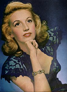 A vintage illustration of a smiling woman posing with her head resting on her right hand.