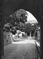 Looking through the gate, the shooting holes can be seen in the old piece of city wall on the left.