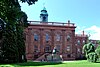 Front facade of building, with statue