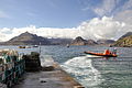 Image 35A boat leaving a slipway stacked with creels in Elgol Bay, Skye, with the Cuillin in the background Credit: Paul Hermans