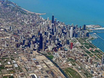 The Chicago Loop with the platforms and tracks of LaSalle Street Station visible in the foreground east of the Chicago River. Union Station and its tracks can be seen west of the Chicago River.