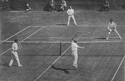 1912 International Lawn Tennis Challenge (Davis Cup) finals match between Australasia and the British Isles played at the Albert Ground in Melbourne, Australia on 28–30 November. Players shown on the near side are Alfred Dunlop (left) and Norman Brookes (right) for Australasia and on the far side James Cecil Parke (left) and Alfred Beamish (right) for the British Isles.