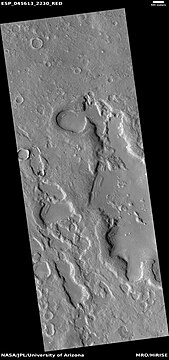 Wide view of dipping layers along mesa walls, as seen by HiRISE under HiWish program Location is Ismenius Lacus quadrangle.