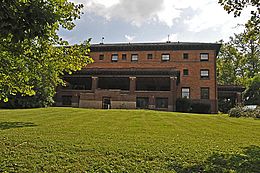 The orange brick façade of the Telluride House as seen from West Ave