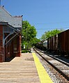 A freight train passes through Laurel station.