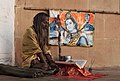 A Sadhu and a picture of Siva in Kayasth Tola, Varanasi, Uttar Pradesh in Northern India