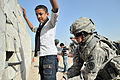 Image 25U.S. Army soldier searches an Iraqi boy, March 2011. (from History of Iraq)