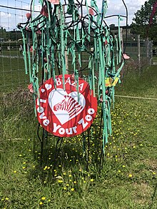 red sign with BIAZA Love Your Zoo printed upon in, on a wire frame sculpture of an animal