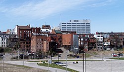 Historic buildings line St. Paul Street in Downtown St. Catharines; the former bed of the First Welland canal is in the foreground.