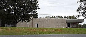 A one-story office building with a small entrance area and mostly blank front wall