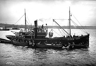 Norwegian fishing vessel with dories alongside, 1938