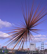 A three-dimensional series of rust-coloured metal spikes with a common origin in the centre, symbolising an explosion