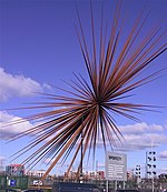 A three-dimensional series of rust-coloured metal spikes with a common origin in the centre, symbolising a explosion