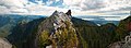 bare rock subpeak with one hiker on top with Vancouver in the background