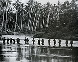 A U.S. Marine patrol crosses the Matanikau River on Guadalcanal in September 1942