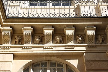 Mascarons on the courtyard balcony frise