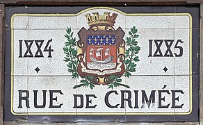 Plaque sur le bâtiment annexe, avec la date de construction du pont et le blason de Paris.