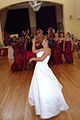 A new bride tossing her flower bouquet over her shoulder.