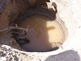 Hand dug well in riverbed.