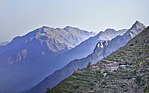 Mountains with terraces and a house on the slope