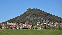 The village of Třebušín with the Kalich hill in the background