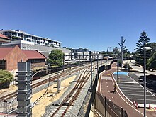 View from a footbridges of a two tracked railway line with a third track in the middle for trains to turn back