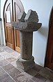 Rø Kirke. Column from the old church in the porch of the new church.