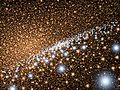 галактика Андромеда, вид на диску молодих блакитних зір, що оточують надмасивну чорну діру. (Зображення художника)